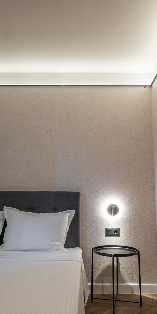 M Star Rooms room interior with bed and reading light